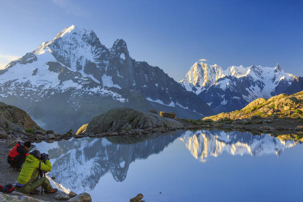 Photographers on the shores of Lac Blanc at sunrise Haute Savoie France Europe