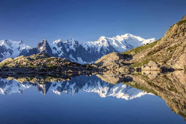 Snowy peaks Mont Blanc massif are reflected in Lac Blanc at dawn Haute Savoie France Europe