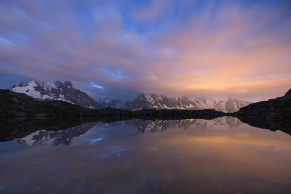 The sky is tinged with pink at dusk on Lac de Cheserys  Chamonix Haute Savoie France Europe
