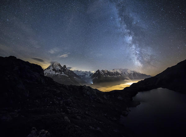 Stars and Milky Way illuminate the snowy peaks around Lac de Cheserys Chamonix Haute Savoie France Europe