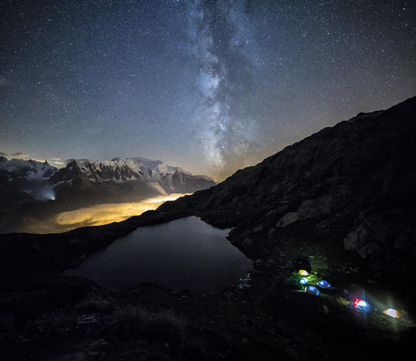 Stars and Milky Way illuminate the snowy peaks around Lac de Cheserys Chamonix Haute Savoie France Europe