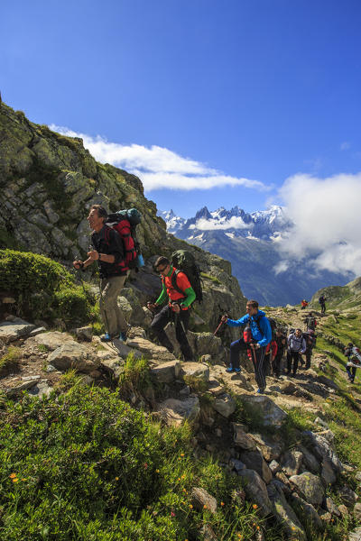 Hikers on the rocky paths around Lac De Cheserys in a sunny summer morning Chamonix Haute Savoie France Europe