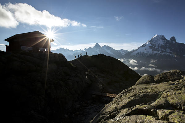 Hikers leave the Refuge Lac De Cheserys to venture on the paths at high altitude Chamonix Haute Savoie France Europe