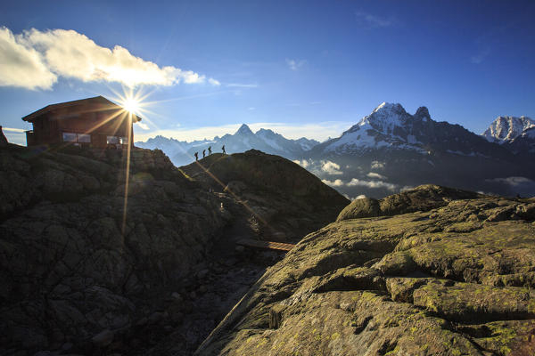 Hikers leave the Refuge Lac De Cheserys to venture on the paths at high altitude Chamonix Haute Savoie France Europe