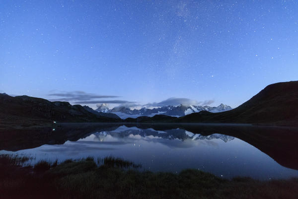 Starry summer sky on Fenetre Lakes and the high peaks Ferret Valley Saint Rhémy Grand St Bernard Aosta Valley Italy Europe