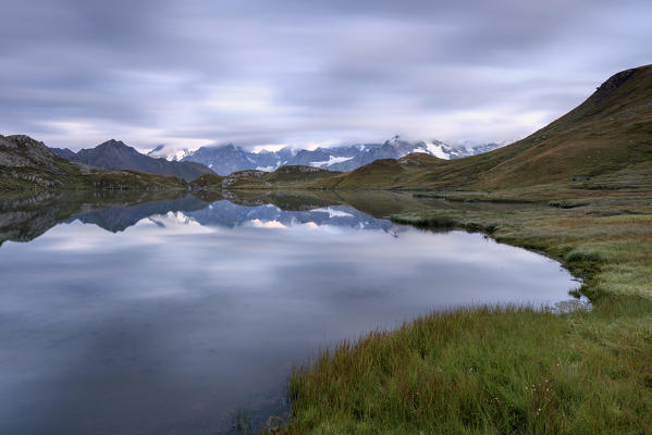 The mountain range is reflected in Fenetre Lakes  Ferret Valley Saint Rhémy Grand St Bernard Aosta Valley Italy Europe