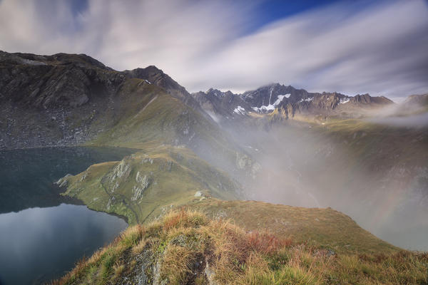 Mist and clouds on high peaks frame the Fenetre Lakes Ferret Valley Saint Rhémy Grand St Bernard Aosta Valley Italy Europe