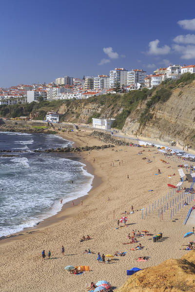 Top view of the village of Ericeira with the ocean waves crashing on the touristic sandy beach Mafra Portugal Europe