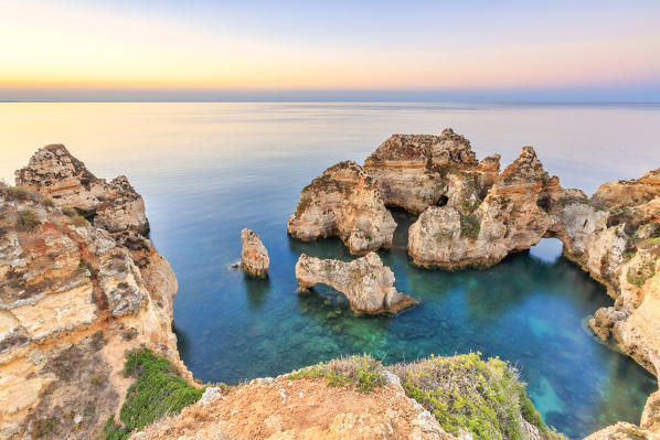 The sky turns pink at dawn on Ponta da Piedade Lagos Algarve Portugal Europe