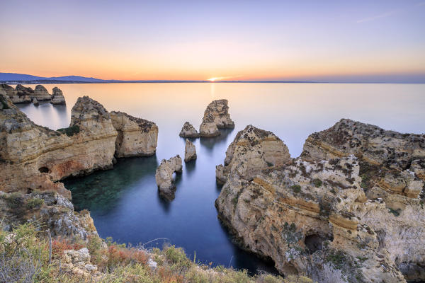 Soft colors of dawn on the  cliffs of Ponta da Piedade Lagos Algarve Portugal Europe