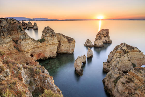 Golden sunrise on the  red cliffs of Ponta da Piedade Lagos Algarve Portugal Europe