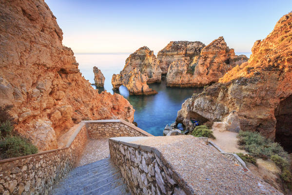 Soft colors of dawn on the red cliffs of Ponta da Piedade Lagos Algarve Portugal Europe