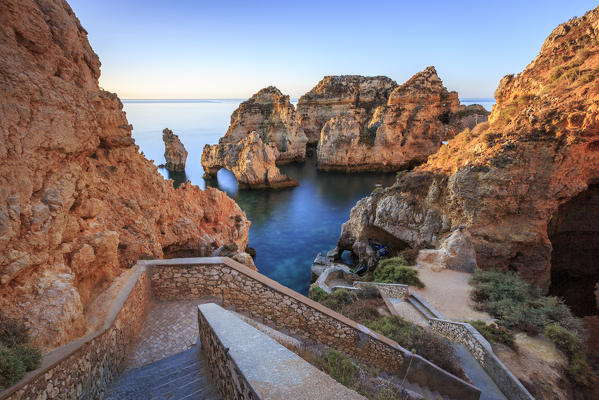 Soft colors of dawn on the red cliffs of Ponta da Piedade Lagos Algarve Portugal Europe