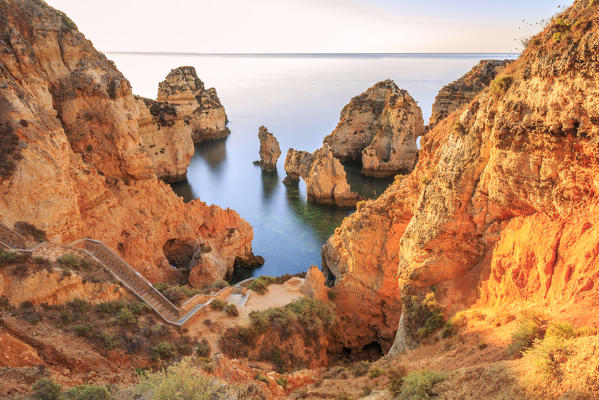 Golden sunrise on the  red cliffs of Ponta da Piedade Lagos Algarve Portugal Europe