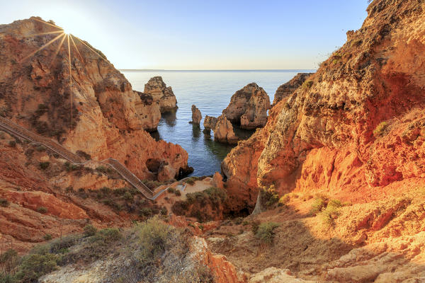 Golden sunrise on the  red cliffs of Ponta da Piedade Lagos Algarve Portugal Europe