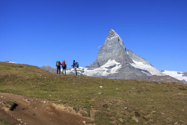 Hikers and photographers admire the Matterhorn in a clear summer day Gornergrat Canton of Valais Switzerland Europe