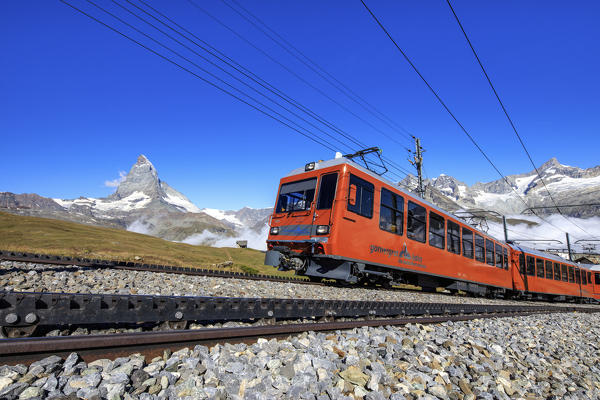 The swiss Bahn train runs on its route with the Matterhorn in the background Gornergrat Canton of Valais Switzerland Europe