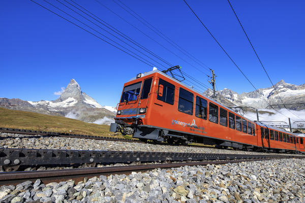 The swiss Bahn train runs on its route with the Matterhorn in the background Gornergrat Canton of Valais Switzerland Europe