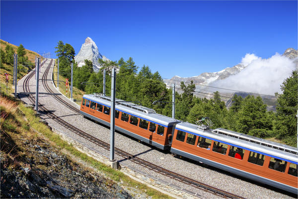 The swiss Bahn train runs on its route with the Matterhorn in the background Gornergrat Canton of Valais Switzerland Europe