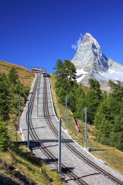 The swiss Bahn train runs on its route with the Matterhorn in the background Gornergrat Canton of Valais Switzerland Europe