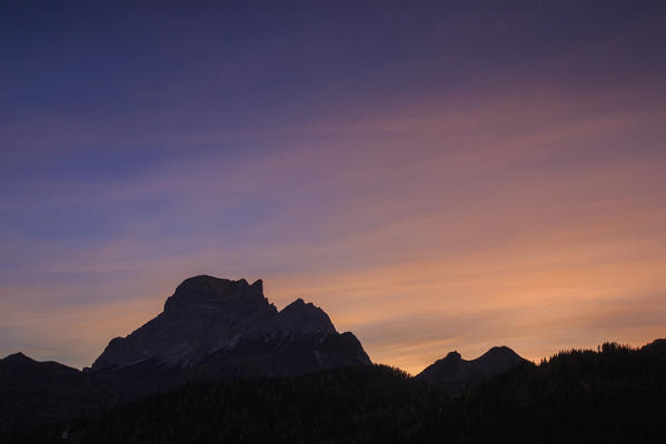 The sky turns pink at sunset on the rocky summit of Mount Pelmo Cadore Zoldo Dolomites Veneto Italy Europe