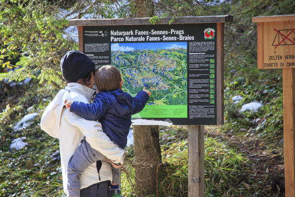Mother and son look at the map of paths around Lake Braies Natural Park Fanes Sennes Bolzano Trentino Alto Adige Italy Europe