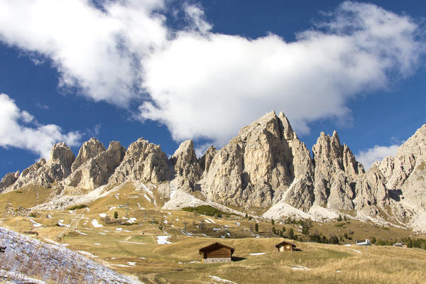 Blue sky and clouds on the high rocky peaks at Gardena Pass South Tyrol Trentino Alto Adige Italy Europe