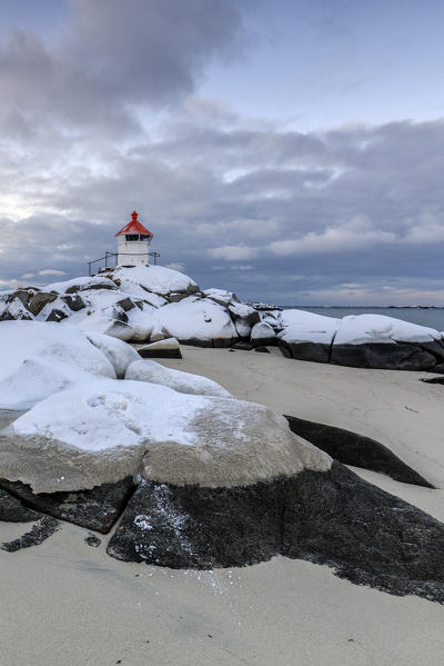 The blue arctic dusk on the lighthouse surrounded by snow and icy sand Eggum Vestvagoy Island Lofoten Islands Norway Europe