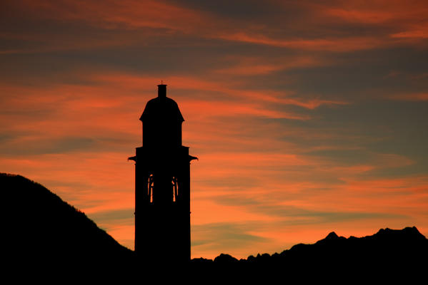Sunset on the bell tower of Soglio. Bregaglia valley Switzerland. Europe