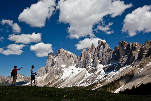 Hiker to Brogler Pass admire the group of Odle of Funes.  Dolomites. Trentino Alto Adige. Italy Europe