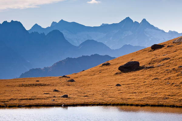 The peaks of the Valley of Chiareggio on the horizon from the bottom of Lake Campagneda. Valmalenco. Valtellina. Lombardy Italy Europe