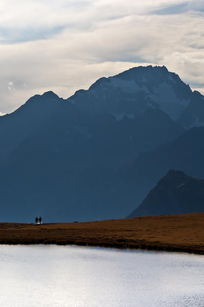 The unmistakable silhouette of Mount Disgrazia stands majestic on Lake Campagneda. Valmalenco. Lombardy. Italy Europe