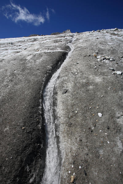 The melt water has dug a bed in Glacier Vazzeda. Valmalenco. Valtellina Lombardy. Italy Europe