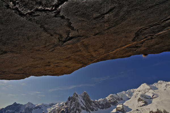 View of the tips of Medaccio and Fiorelli from beneath a granite rock of Val Ligoncio. Valmasino. Valtellina. Lombardy Europe