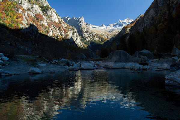 Peaks of Mount Disgrazia and peak of Pioda are reflected in a pool created by a landslide in Mello Valley. Valmasino. Valtellina. Lombardy Italy Europe