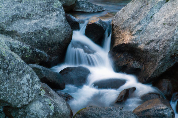 The water of a river makes jumps between the granite rocks of Mello valley. Valmasino. Valtellina. Lombardy Italy Europe