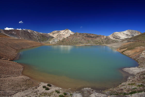 Lake Salin a small body of water on arrival of the ski lifts in Livigno used for artificial snow for the ski slopes in winter. Carosello 3000. Livigno Valtellina. Lombardy Italy Europe