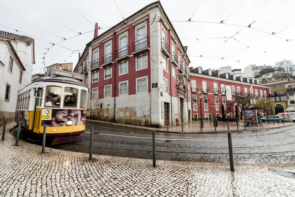 Yellow tram number 28 performs the longest route leading from centre of town up to the top of Alfama Lisbon Portugal Europe