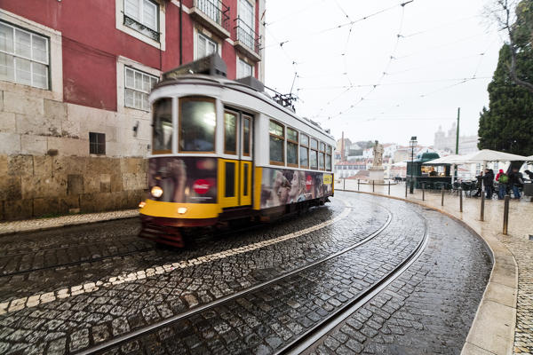 Yellow tram number 28 performs the longest route leading from centre of town up to the top of Alfama Lisbon Portugal Europe