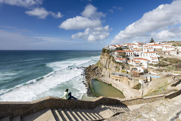 Tourist admires the perched village of Azenhas do Mar overlooking the Atlantic ocean Sintra Portugal Europe