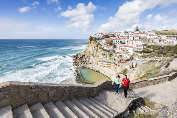 Top view of the perched village of Azenhas do Mar surrounded by the crashing waves of the Atlantic Ocean Sintra Portugal Europe