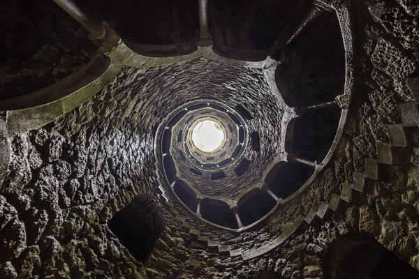 Spiral stairs and mystical atmosphere inside the towers of Initiation Well at Quinta da Regaleira Sintra Portugal Europe