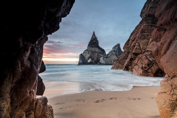 The colors of sunset over the ocean surrounded by cliffs before dusk Praia da Ursa Cabo da Roca Colares Sintra Portugal Europe
