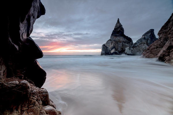 The colors of sunset over the ocean surrounded by cliffs before dusk Praia da Ursa Cabo da Roca Colares Sintra Portugal Europe