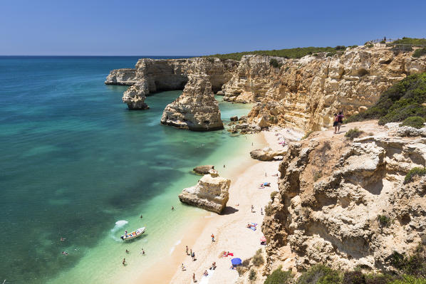 Top view of cliffs and turquoise water of the ocean Praia da Marinha Caramujeira Lagoa Municipality Algarve Portugal Europe