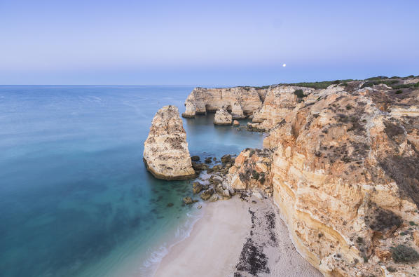 Top view of cliffs and turquoise water of the ocean Praia da Marinha Caramujeira Lagoa Municipality Algarve Portugal Europe