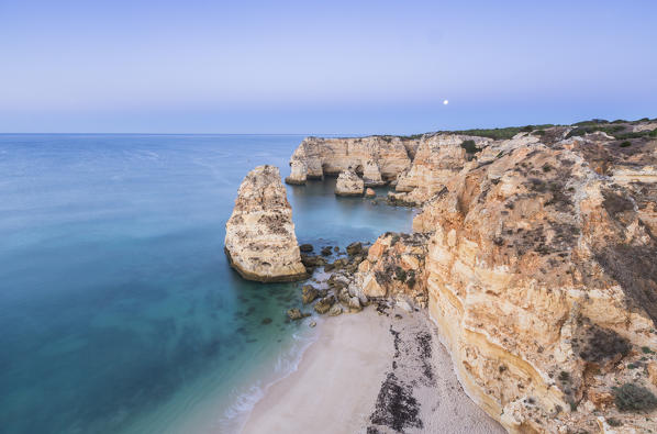 Top view of cliffs and turquoise water of the ocean Praia da Marinha Caramujeira Lagoa Municipality Algarve Portugal Europe