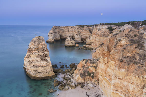 Top view of cliffs and turquoise water of the ocean Praia da Marinha Caramujeira Lagoa Municipality Algarve Portugal Europe