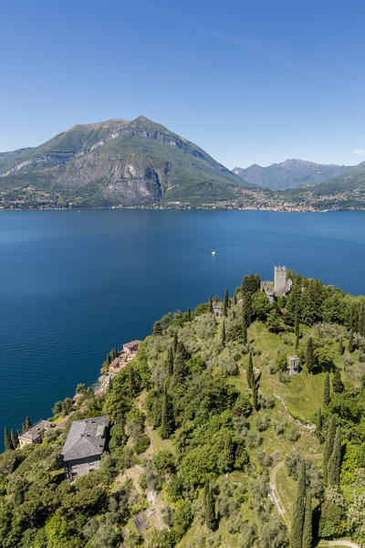 Aerial view of the green hill and castle overlooking Varenna surrounded by Lake Como Lecco Province Lombardy Italy Europe