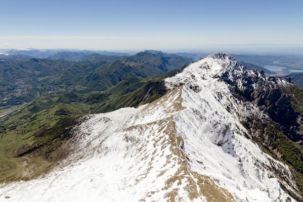 Aerial view of the snowy ridges of Grignetta and Resegone with the lake in the background Lecco Province Lombardy Italy Europe